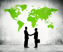 partners_shaking_hands_in_front_of_a_map