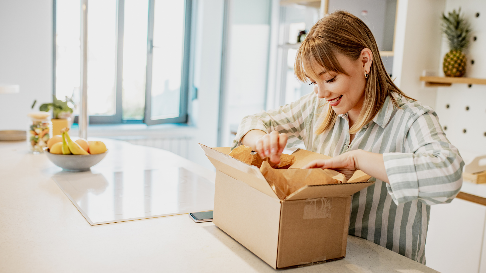 oung woman unpack the package she ordered online 